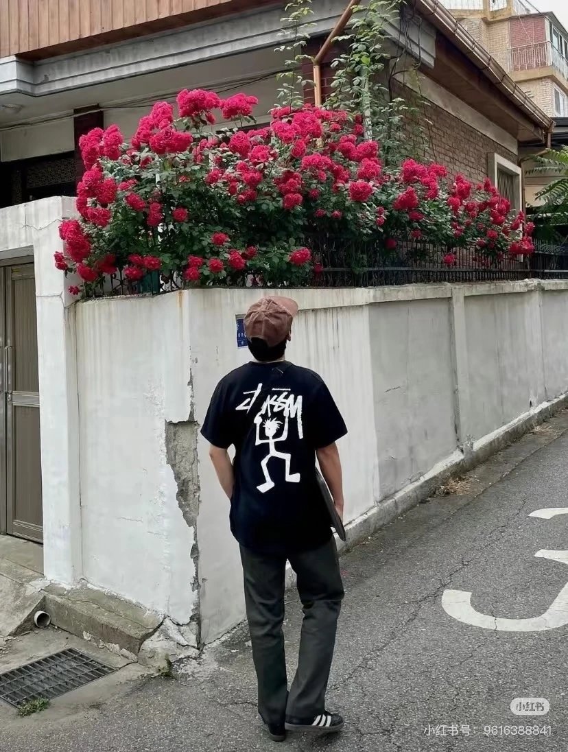 Black T-shirt with white stick figure and text graphic print by KasaM