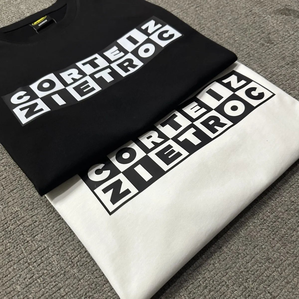 Corteiz Cartoon Network White XL Tee with grid – style logo print